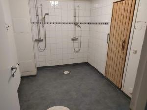 an empty bathroom with a shower and a toilet at Romme stugby in Borlänge