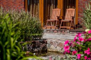two chairs sitting on the porch of a house at Vila Sraige in Palanga +16 photos