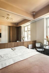 a bedroom with a large bed and a mirror at Angelus Apartments in Kraków