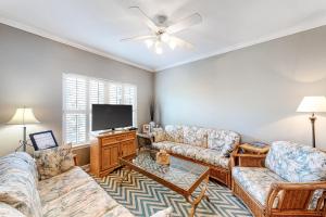 a living room with two couches and a flat screen tv at Dauphin Island Beach Club #201 in Dauphin Island