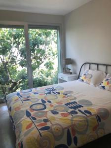 a bed with a colorful comforter in a bedroom at Casa do Eido dos Calhões in Ponte de Lima +25 photos