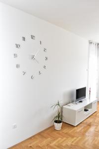 a white room with a clock on the wall at Apartman Dajana in Trebinje
