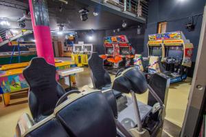 a play room with a bunch of arcade games at Beach Hostel Balatonboglár in Balatonboglár +28 photos