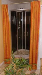 a window with orange curtains in a room at Alain et Flo in Charancieu