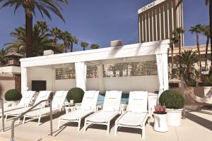 a patio area with chairs, tables and umbrellas at Delano Las Vegas at Mandalay Bay in Las Vegas