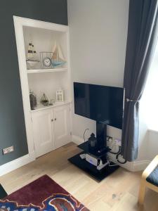 a living room with a large flat screen tv at Beach Way in Berwick-Upon-Tweed