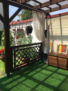 a screened in porch with a fence and green grass at Domek Kasi in Ustka