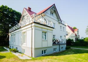 a large white house with a red roof at roomsy guest house in Sopot