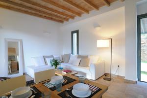 a living room with a white couch and a table at Aegea Blue Cycladic Resort in Zorgos 