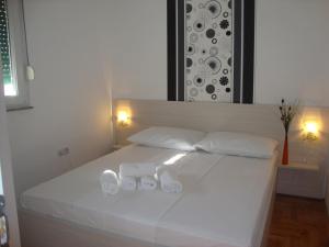 a white bed with two white towels on it at Apartments Marina in Vodice