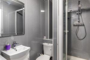 a bathroom with a toilet and a sink and a shower at Sunderland City Centre Apartments free parking and Wi-Fi in Sunderland