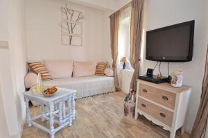 a living room with a couch and a flat screen tv at Bell Tower Apartment in Budva
