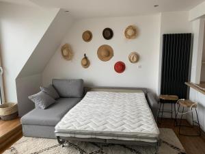a bedroom with a bed and hats on the wall at « Rêve de mer » appartement face mer in Le Portel