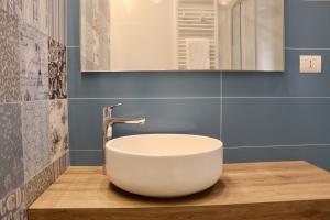 a bathroom with a white bowl sink on a wooden counter at Cetara Costa d'Amalfi Residence in Cetara