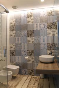 a bathroom with two sinks and a glass shower at Cetara Costa d'Amalfi Residence in Cetara