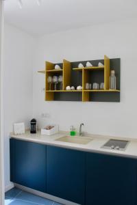 a kitchen with a blue and white counter and shelves at Cetara Costa d'Amalfi Residence in Cetara