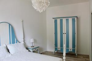 a bedroom with a bed and a blue cabinet at Cetara Costa d'Amalfi Residence in Cetara