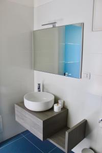 a bathroom with a sink and a mirror at Cetara Costa d'Amalfi Residence in Cetara