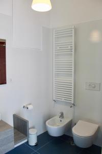a white bathroom with a toilet and a sink at Cetara Costa d'Amalfi Residence in Cetara