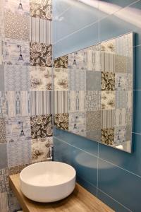 a bathroom with a white sink and a mirror at Cetara Costa d'Amalfi Residence in Cetara