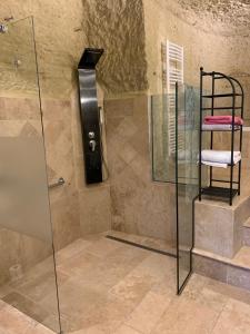a shower with a glass door and a towel rack at Au Petit Nice in Nazelles +3 photos