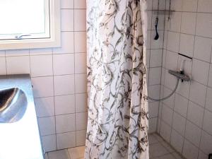 a shower curtain in a bathroom next to a sink at 6 person holiday home in Dannemare in Dannemare