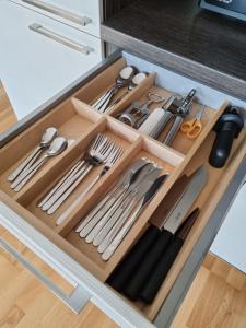 a drawer filled with utensils in a kitchen at R63 Apartment with Terrace in Tartu
