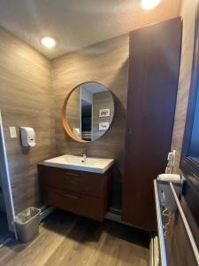 a bathroom with a sink and a mirror at Banff International Hostel in Banff