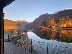 a view of a lake with mountains in the background at Stryn Crystal Apartments B, Waterfront Apartment in Stryn