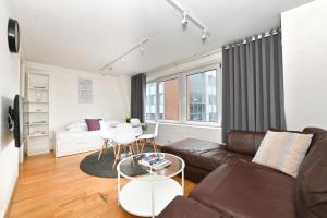 a living room with a couch and a table at Oxford Street & Carnaby - Soho Abode Apartments in London