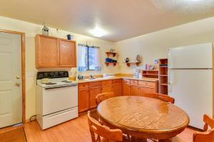 a kitchen with a table and a white refrigerator at The Pit Stop in Duck Creek Village