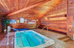a jacuzzi tub in a room with a wooden ceiling at Giant Steps 28 Ski in out in Brian Head