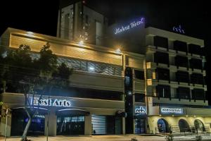 a building with a sign on the side of it at Hotel Modena - São José dos Campos in São José dos Campos