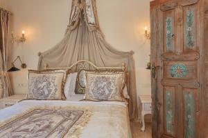 a bedroom with a large bed with a canopy at Lukka Exclusive Hotel – Adult Only +12 in Kaş