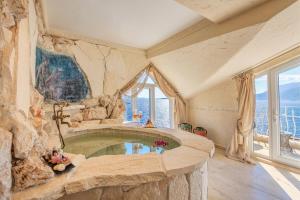 a large stone tub in a room with windows at Lukka Exclusive Hotel – Adult Only +12 in Kaş