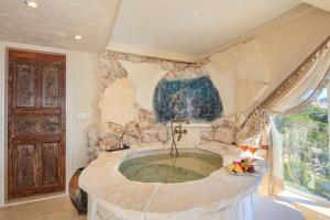 a large stone tub in a room with a window at Lukka Exclusive Hotel – Adult Only +12 in Kaş