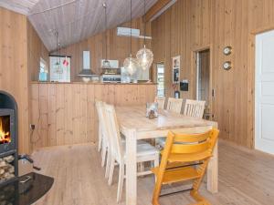 a dining room with a table and chairs and a fireplace at 8 person holiday home in Glesborg in Glesborg