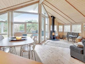 uma sala de estar com uma mesa e uma lareira em 6 person holiday home in Slagelse em Slagelse