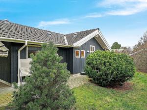 a house with two trees in front of it at 6 person holiday home in Slagelse in Slagelse