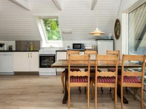 een keuken met een eettafel en stoelen bij 6 person holiday home in Ebeltoft in Ebeltoft