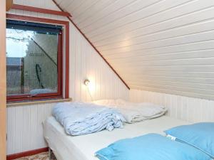 two beds in a room with a window at 6 person holiday home in Ebeltoft in Ebeltoft