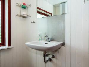 a white sink in a bathroom with a mirror at 6 person holiday home in Ebeltoft in Ebeltoft