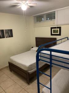 two bunk beds in a room with a ceiling fan at Boqueron vacation in Boqueron