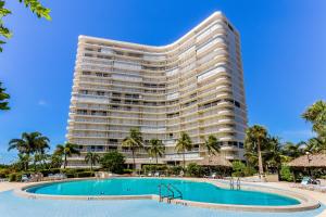 a large hotel with a swimming pool and a resort at South Seas Sunsations in Marco Island