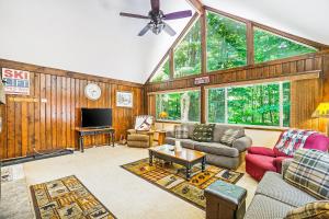 a living room filled with furniture and a large window at Ski Tips Up in Thompsonville