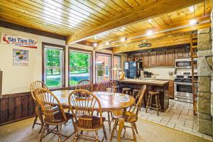 a kitchen with a dining room table and chairs at Ski Tips Up in Thompsonville