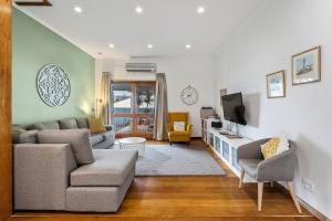 a living room with a couch and a tv at Jack's House 2 B&B in Mill Street in Clare