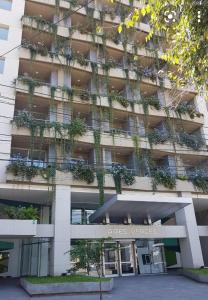 an office building with plants on the facade at Aires Verdes Salta in Salta
