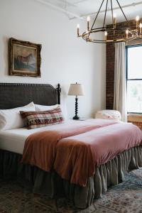 a bedroom with a large bed and a chandelier at The Inn in Buena Vista +20 photos