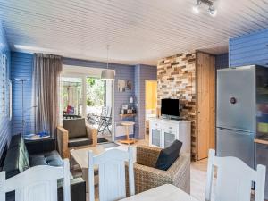 a living room with a couch and a kitchen with a refrigerator at Lavender holiday home with private terrace in Grimaud